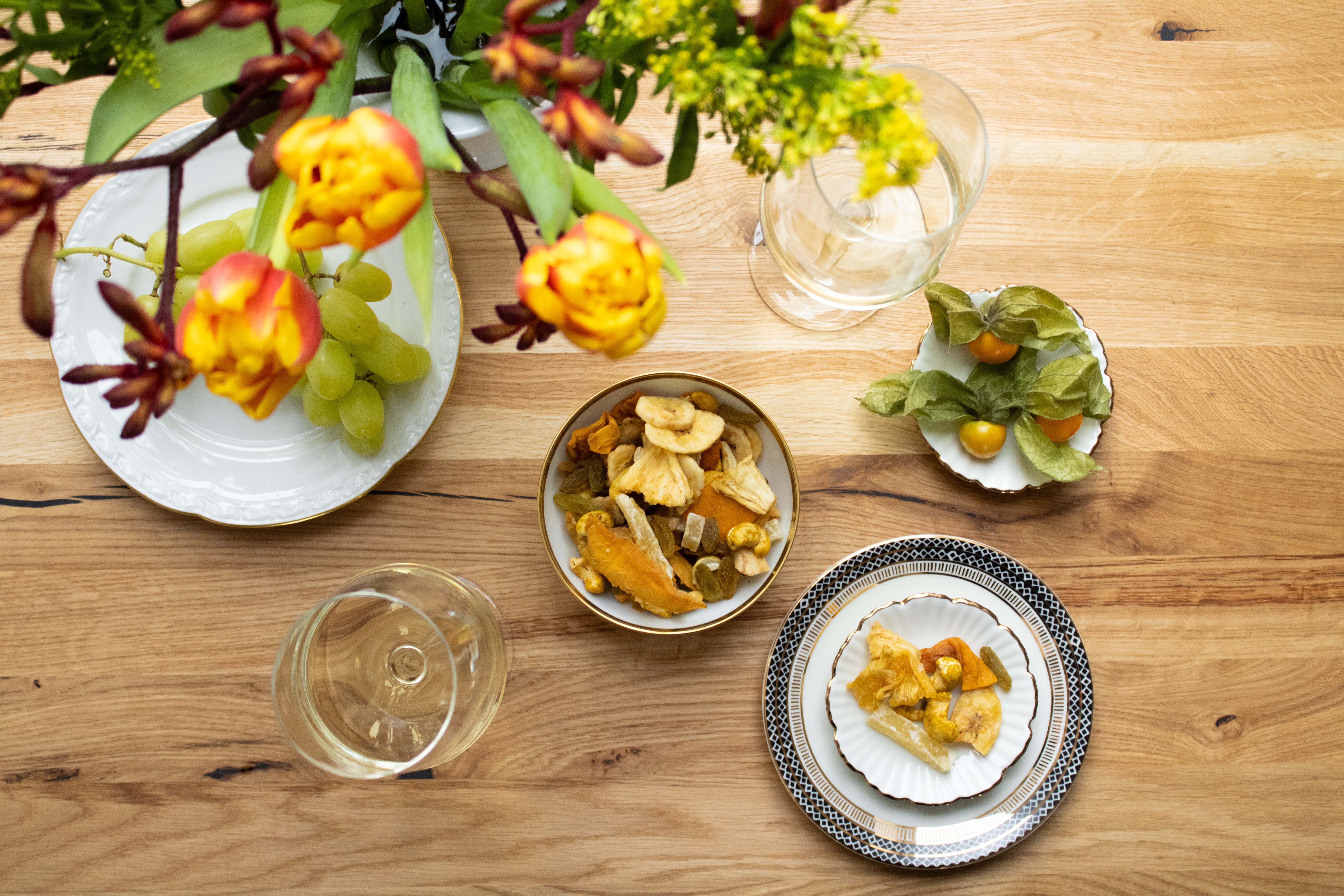 Zwei Schalen mit einer Nuss-Trockenfrucht Mischung  Weinbegleiter No. 4 zum Weißwein auf einem Holztisch schön gedeckt