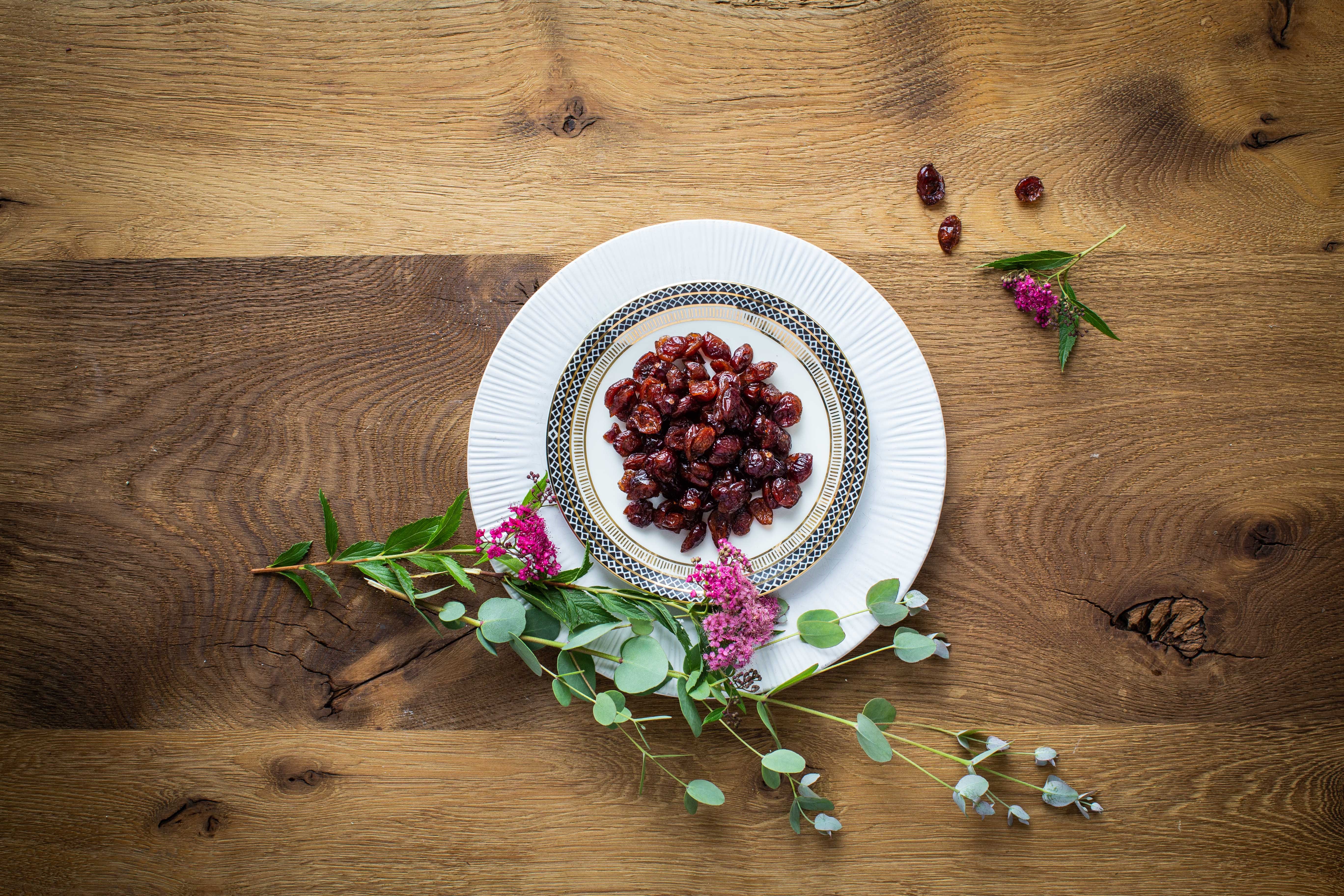 Bio Cranberries auf Tellern auf Holzboden