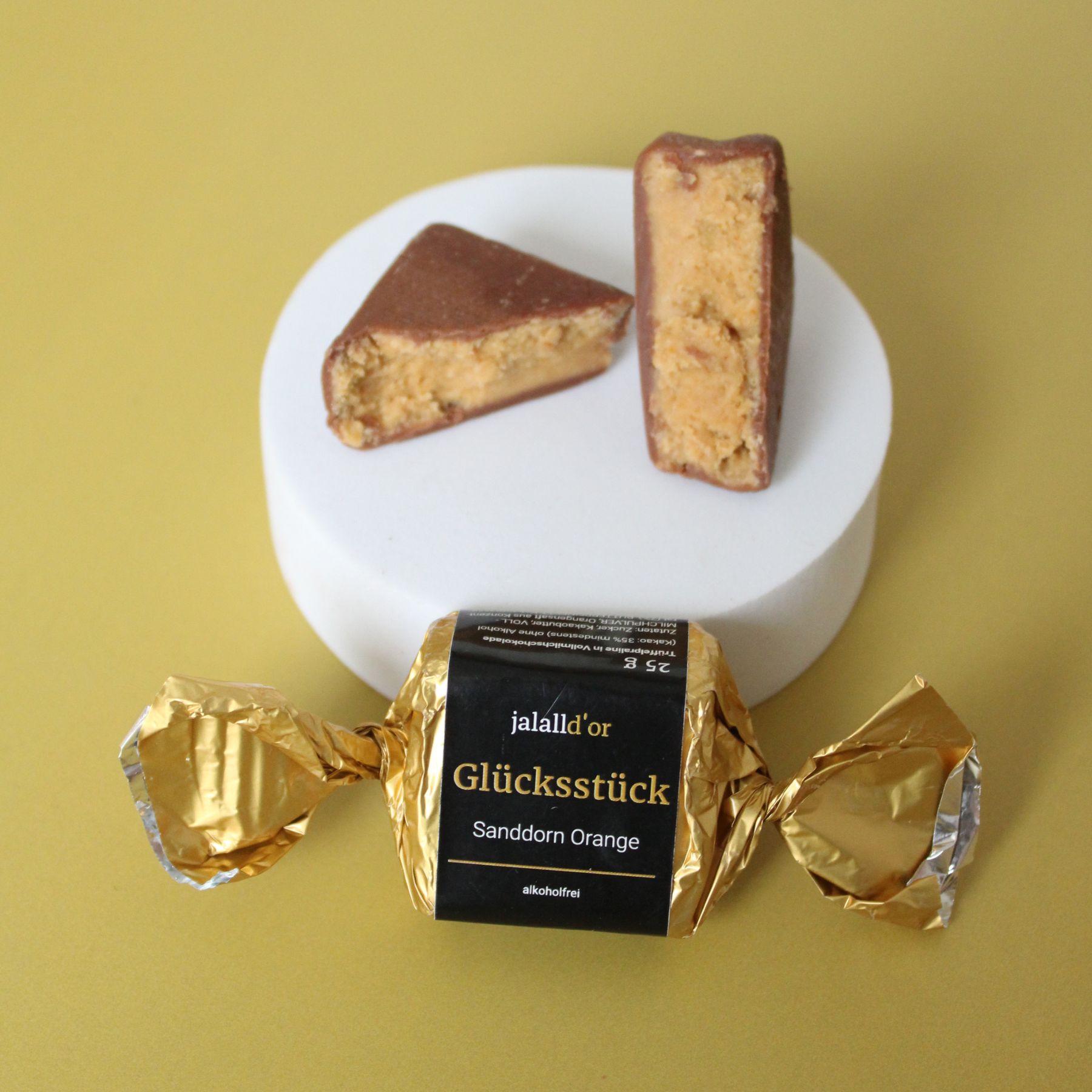 Gluecksstueck Sanddorn Orange in Verpackung und aufgeschnitten